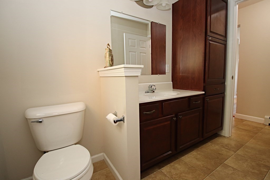 10 Pace Road Saugus, MA 01906 - Photo 17 of 42 a bathroom with a toilet sink vanity and mirror