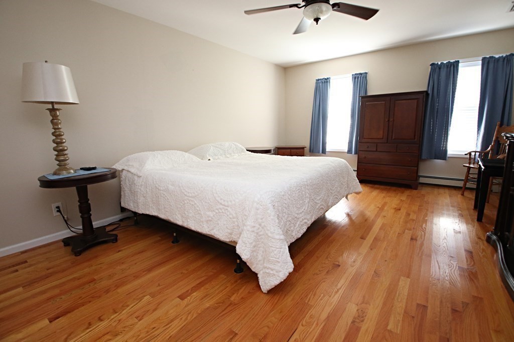 10 Pace Road Saugus, MA 01906 - Photo 21 of 42 a bedroom with a bed and a chandelier