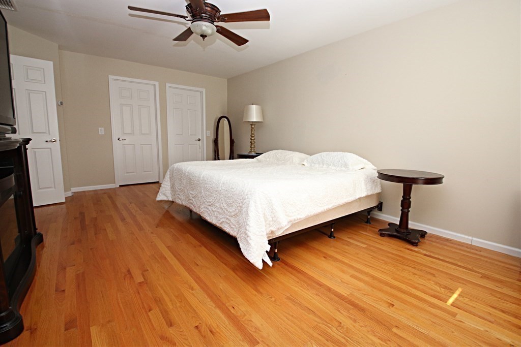 10 Pace Road Saugus, MA 01906 - Photo 22 of 42 a bedroom with a bed and a chandelier