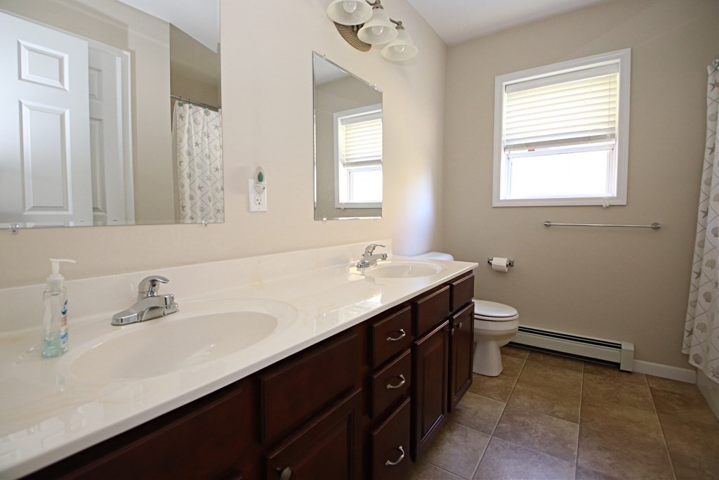 10 Pace Road Saugus, MA 01906 - Photo 32 of 42 a bathroom with a sink and a mirror
