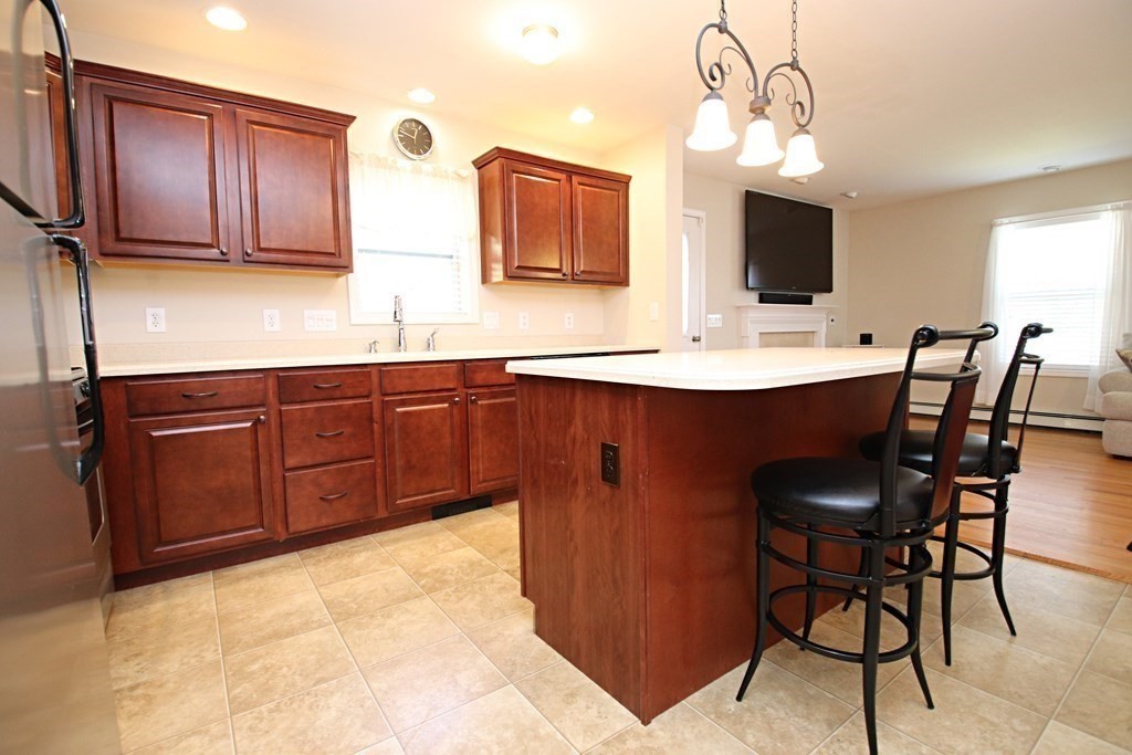 10 Pace Road Saugus, MA 01906 - Photo 7 of 42 a kitchen with stainless steel appliances a sink and cabinets