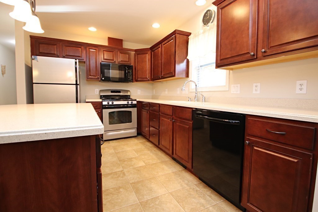 10 Pace Road Saugus, MA 01906 - Photo 9 of 42 a kitchen with stainless steel appliances granite countertop a sink stove and refrigerator