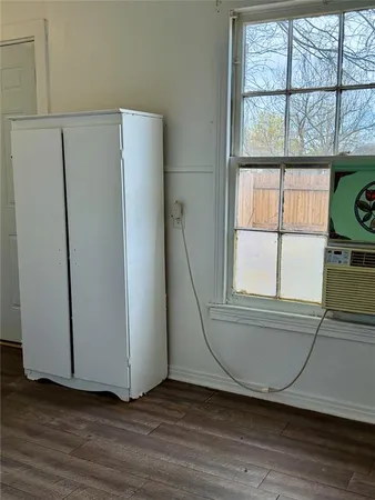 a view of a kitchen with wooden floor and a window