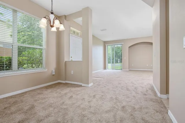 an empty room with windows and outdoor view