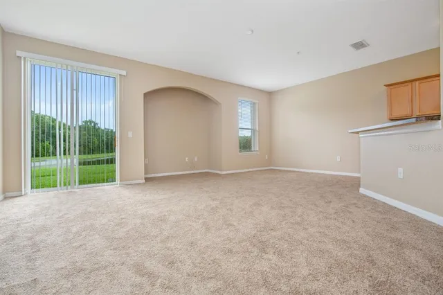 a view of an empty room with glass door