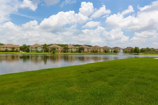 a view of a lake with houses in the background
