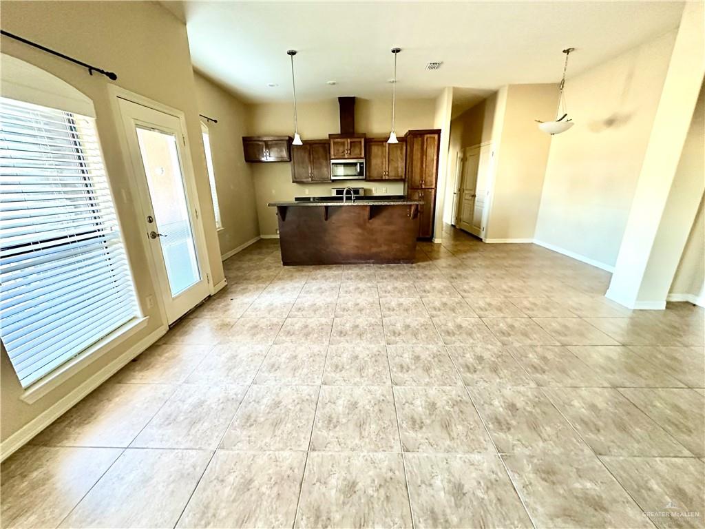2715 Mimosa Street, Unit 3 Mission, TX 78574 - Photo 4 of 13 a kitchen with stainless steel appliances granite countertop a refrigerator and a sink
