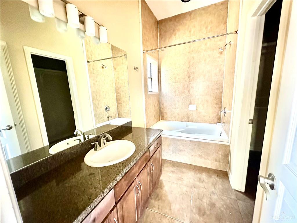 2715 Mimosa Street, Unit 3 Mission, TX 78574 - Photo 10 of 13 a bathroom with a granite countertop sink and a mirror