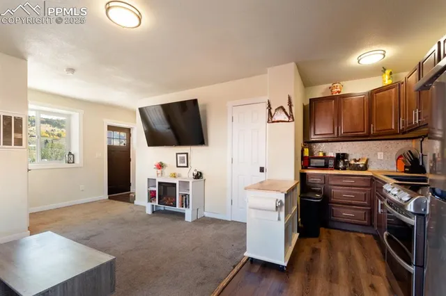 a open kitchen with stainless steel appliances granite countertop a stove and a sink