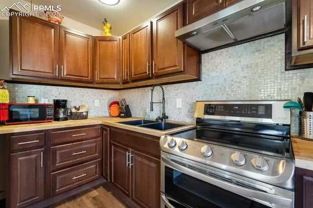 a kitchen with stainless steel appliances granite countertop a stove and a microwave