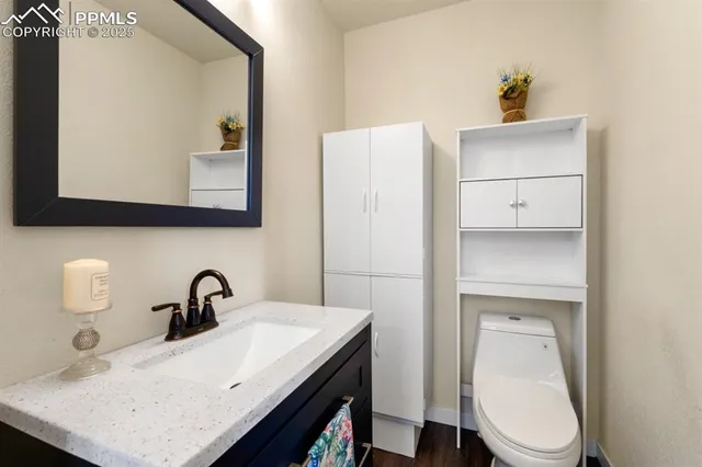 a bathroom with a sink a toilet and mirror