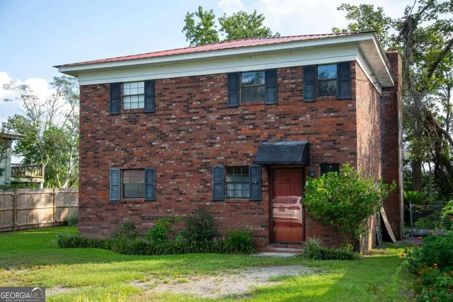a front view of a house with garden