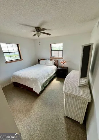 a bedroom with bed and window