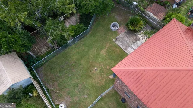 a view of a backyard with fence