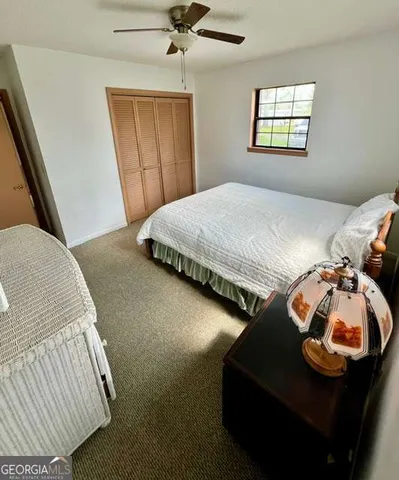 a bedroom with bed and a window