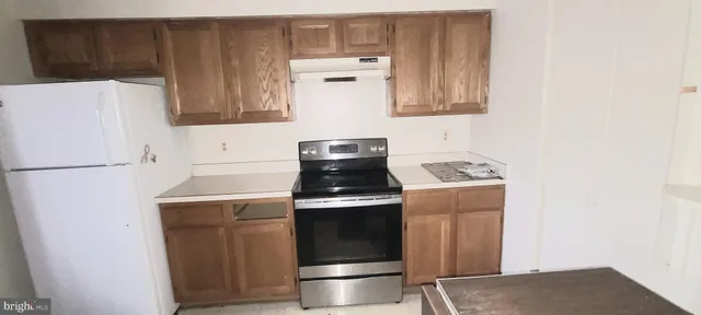 a kitchen with a stove and a refrigerator