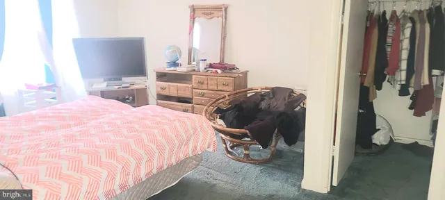 a bed room with a bed and a chair