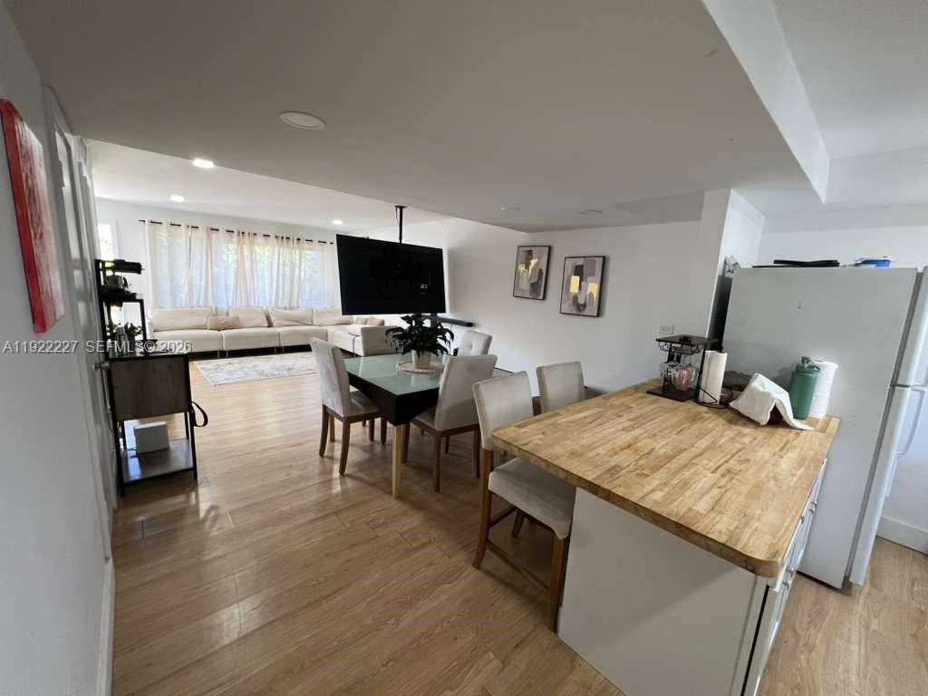 1480 Northeast 151st Street, Unit 101 Miami, FL 33162 - Photo 14 of 26 a living room with furniture and a flat screen tv