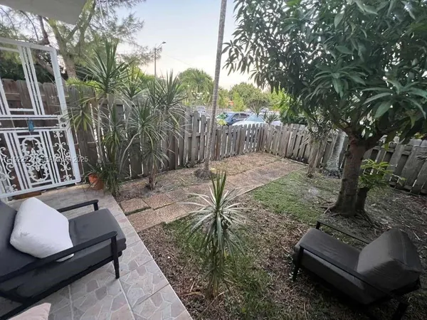 a view of patio with couches and a fire pit