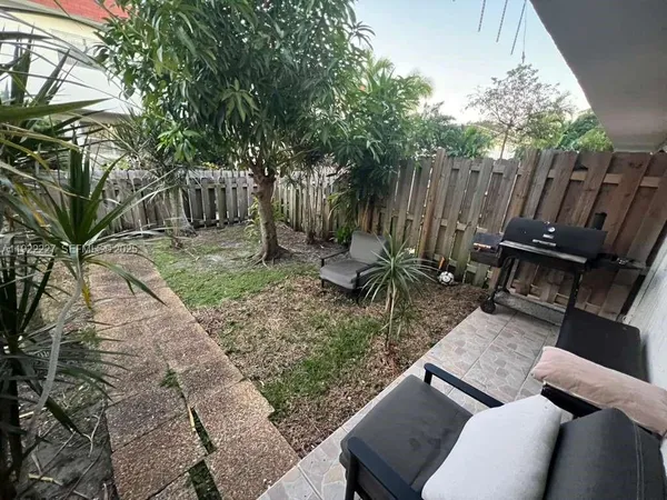 a backyard of a house with table and chairs