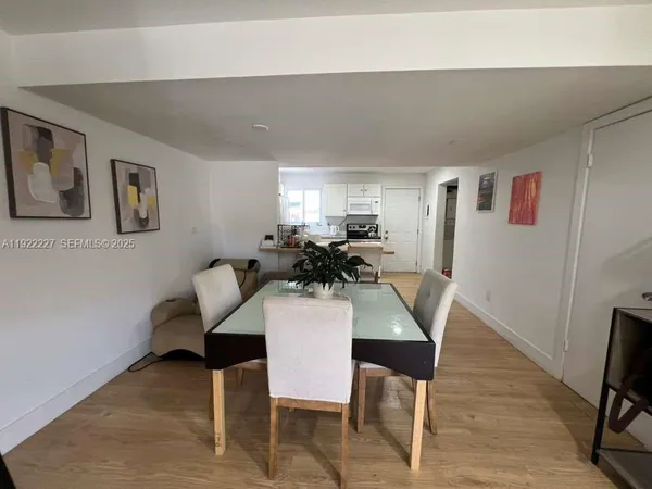 a view of a dining room with furniture and wooden floor