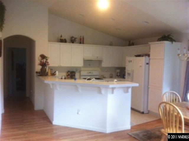 1708 Trek Trail Reno, NV 89521 - Photo 3 of 10 a kitchen with stainless steel appliances a refrigerator a sink a stove and wooden floors