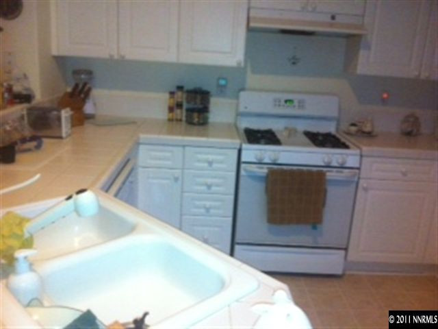1708 Trek Trail Reno, NV 89521 - Photo 4 of 10 a kitchen with a stove and cabinets