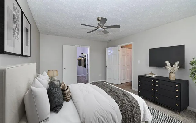 a bedroom with a bed and a flat screen tv