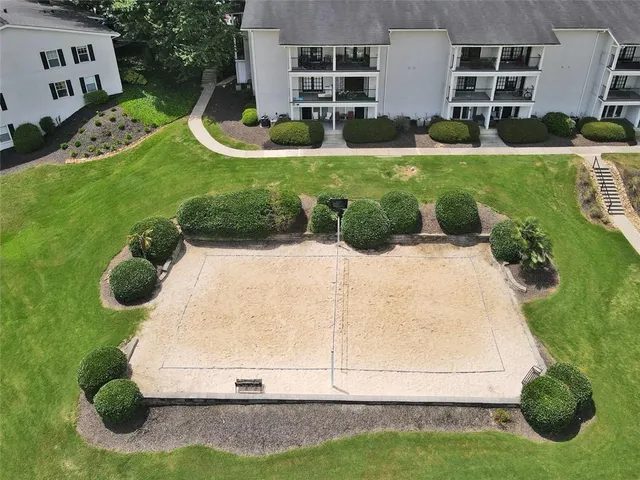 a white house with a yard and plants
