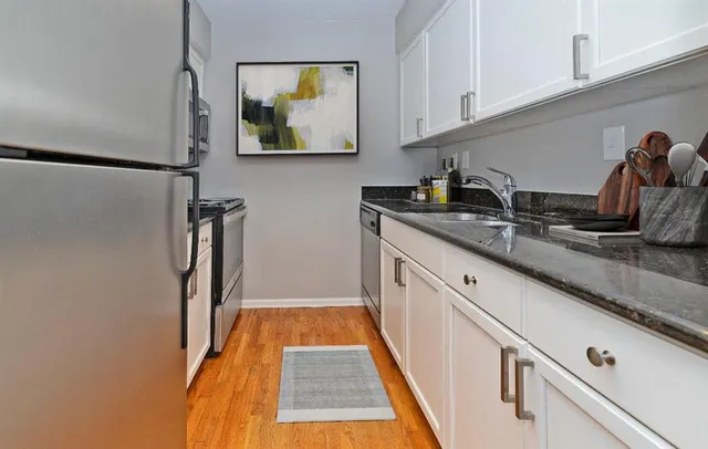 a kitchen with stainless steel appliances granite countertop a sink and cabinets