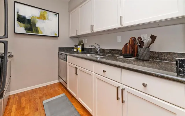 a kitchen with stainless steel appliances granite countertop a sink and cabinets