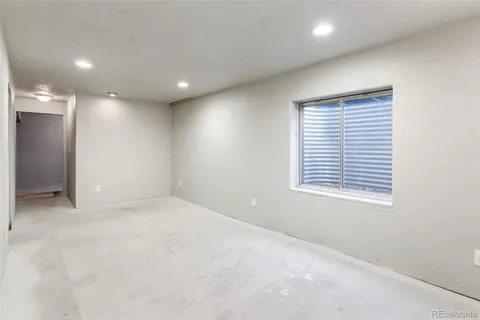 an empty room with windows and closet