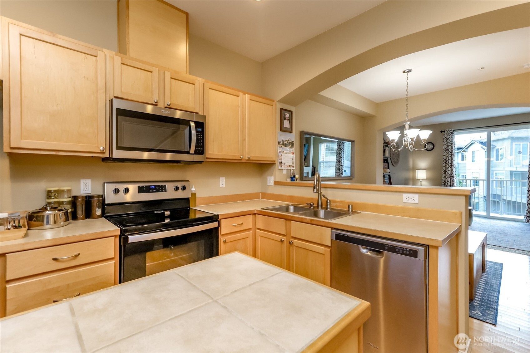 15325 Southeast 155th Place, Unit I3 Renton, WA 98058 - Photo 11 of 31 a kitchen with stainless steel appliances granite countertop a sink a stove a microwave a counter top space and cabinets