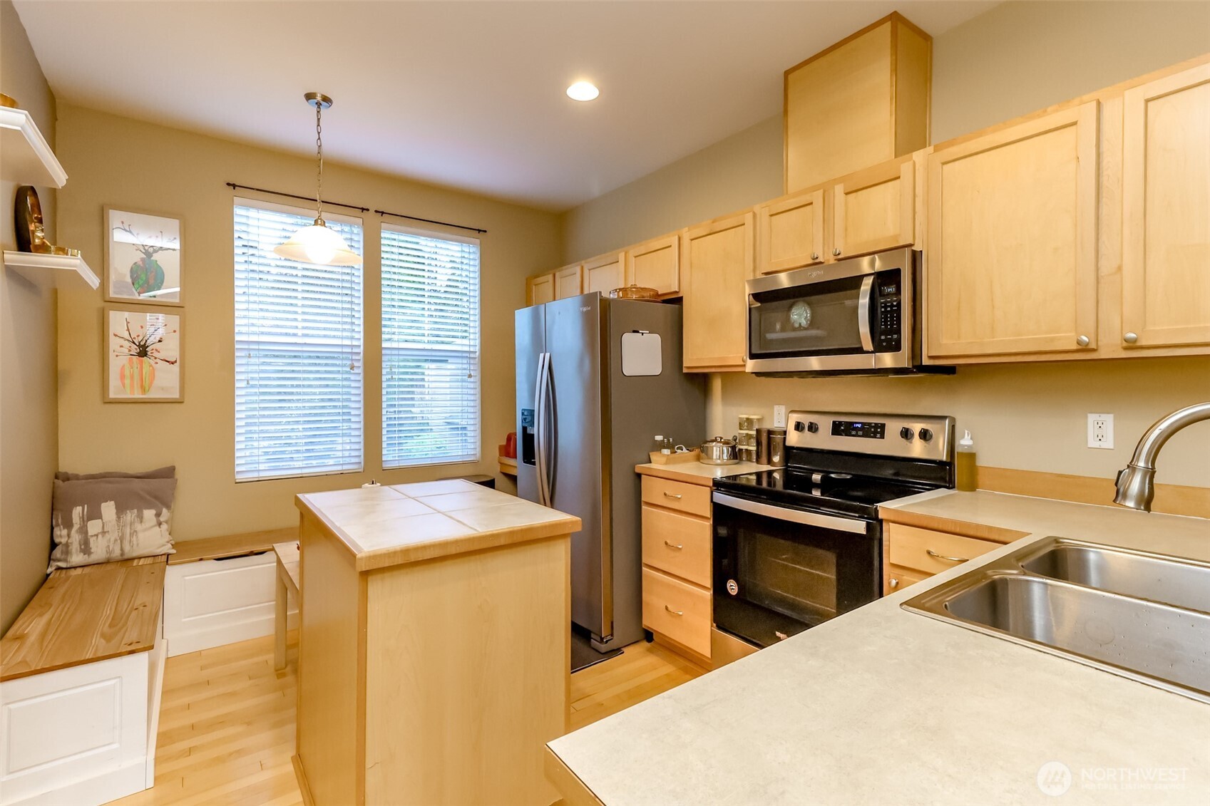 15325 Southeast 155th Place, Unit I3 Renton, WA 98058 - Photo 14 of 31 a kitchen with stainless steel appliances granite countertop a sink a stove a refrigerator cabinets and a dining table
