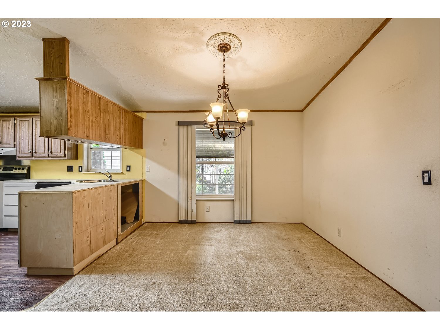 4239 Southeast 122nd Avenue, Unit 14 Portland, OR 97236 - Photo 4 of 11 a kitchen that has a lot of cabinets appliances and a window