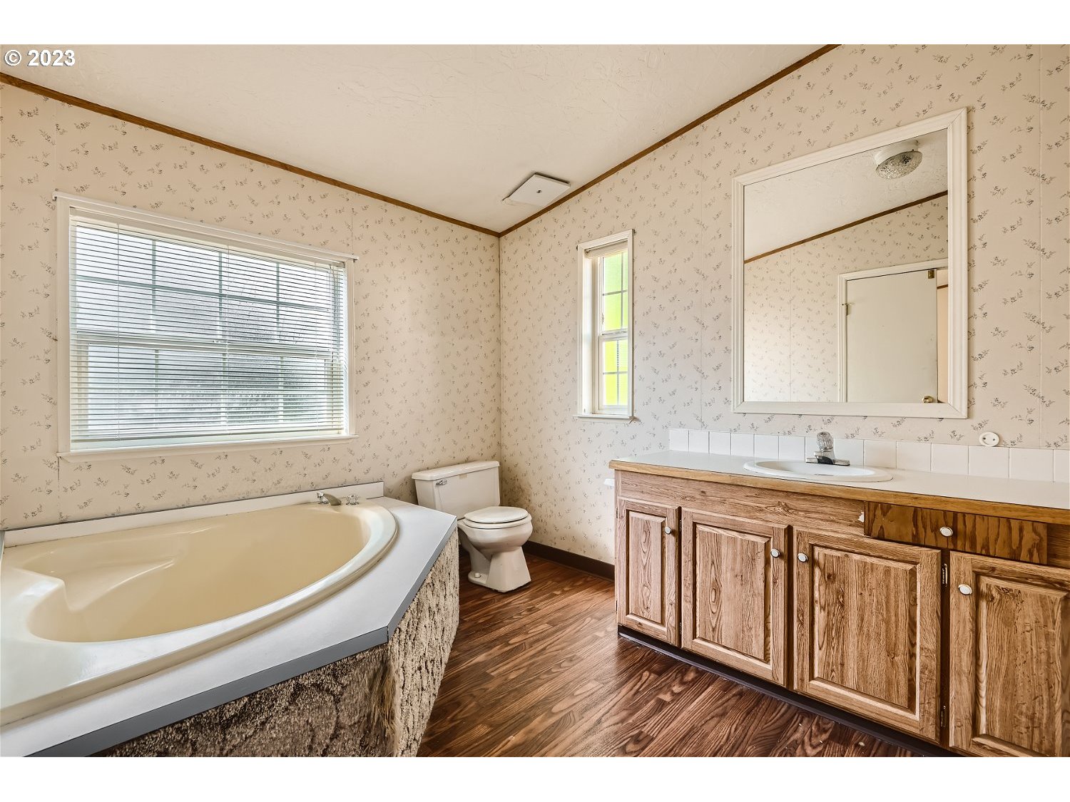 4239 Southeast 122nd Avenue, Unit 14 Portland, OR 97236 - Photo 7 of 11 a bathroom with a granite countertop tub sink and mirror