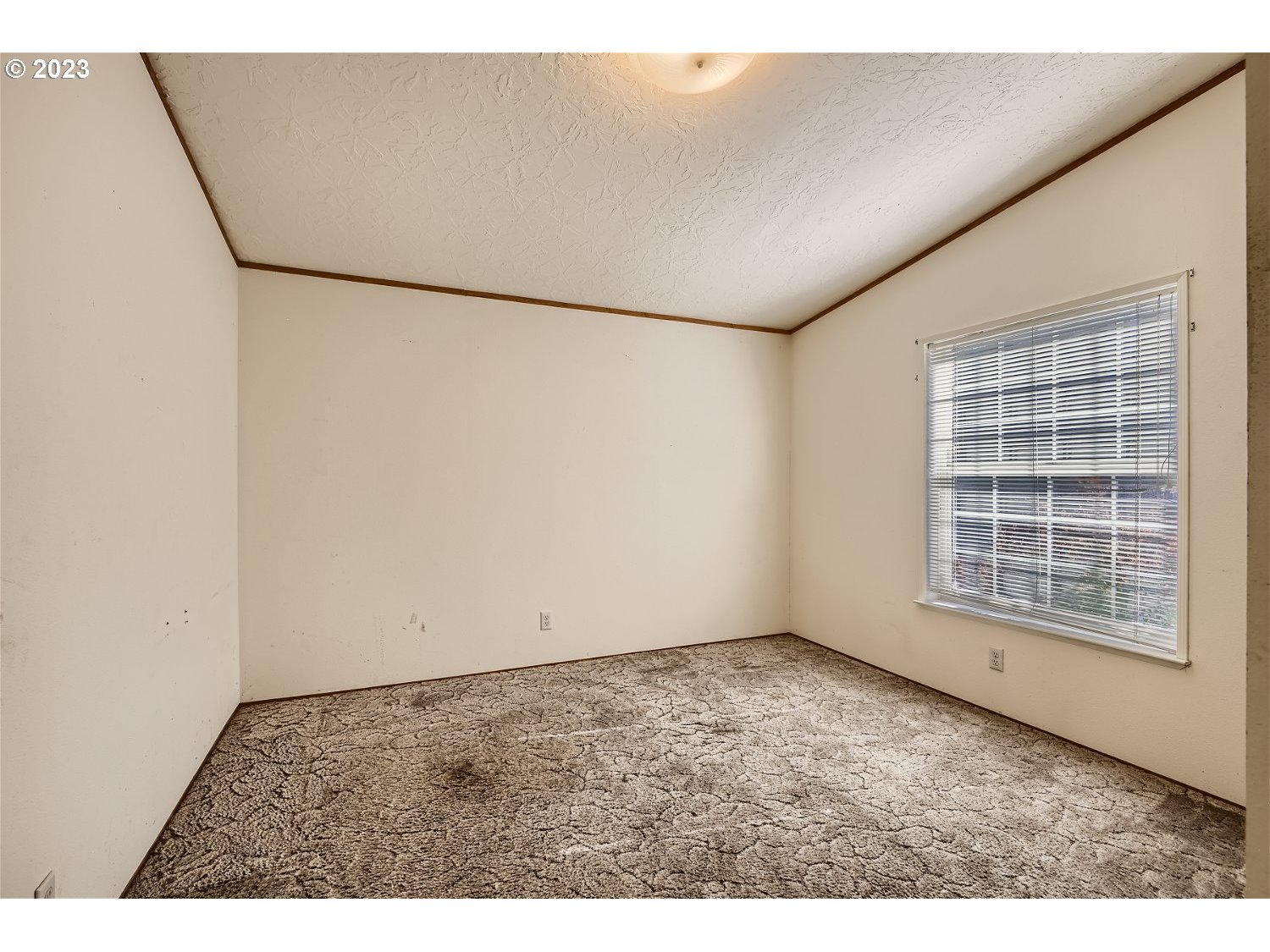4239 Southeast 122nd Avenue, Unit 14 Portland, OR 97236 - Photo 9 of 11 a view of an empty room with a window