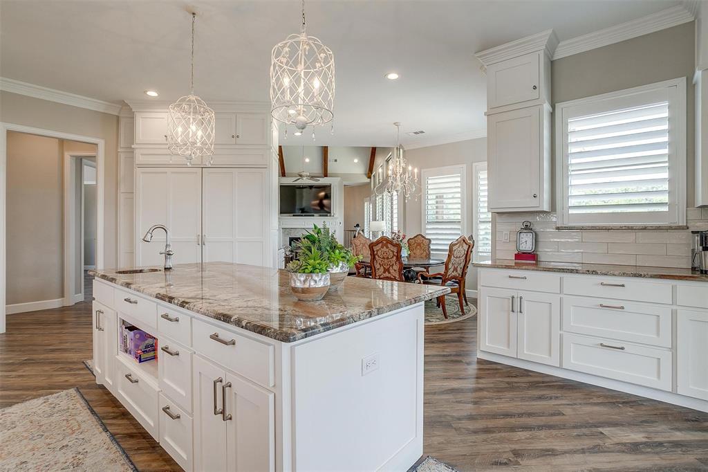 8650 South Fm 730 Boyd, TX 76023 - Photo 15 of 40 Kitchen featuring a kitchen island with sink, backsplash, dark hardwood / wood-style floors, and white cabinets