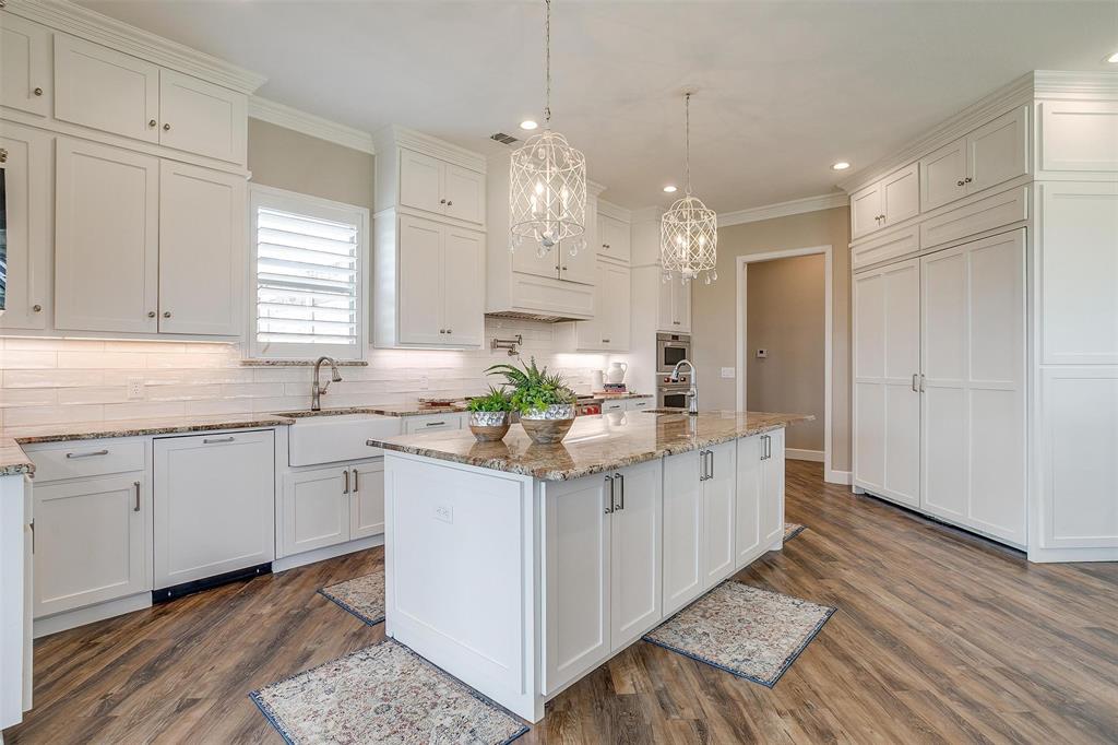 8650 South Fm 730 Boyd, TX 76023 - Photo 16 of 40 Kitchen with backsplash, dark hardwood / wood-style floors, an island with sink, sink, and crown molding