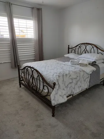 a bed sitting in a bedroom next to a window