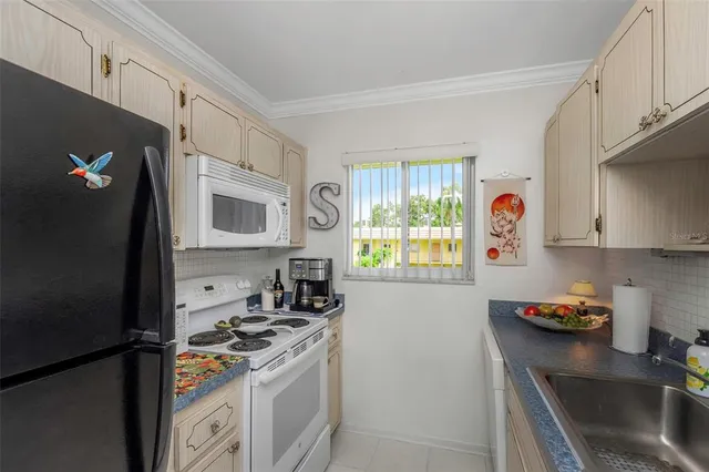 a kitchen with stainless steel appliances granite countertop a sink a stove and a microwave