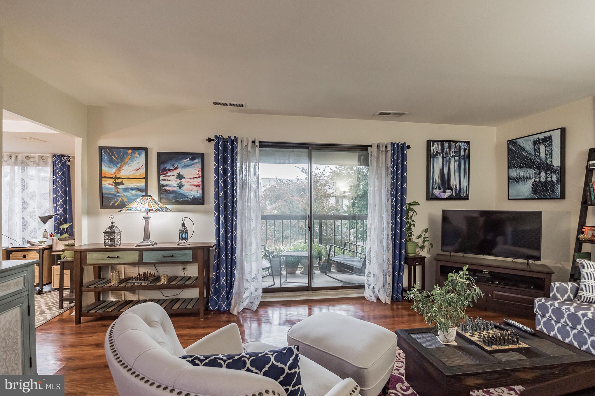 10020 Stedwick Road, Unit 304 Gaithersburg, MD 20886 - Photo 10 of 28 Living Room w/ Fireplace and Balcony Access