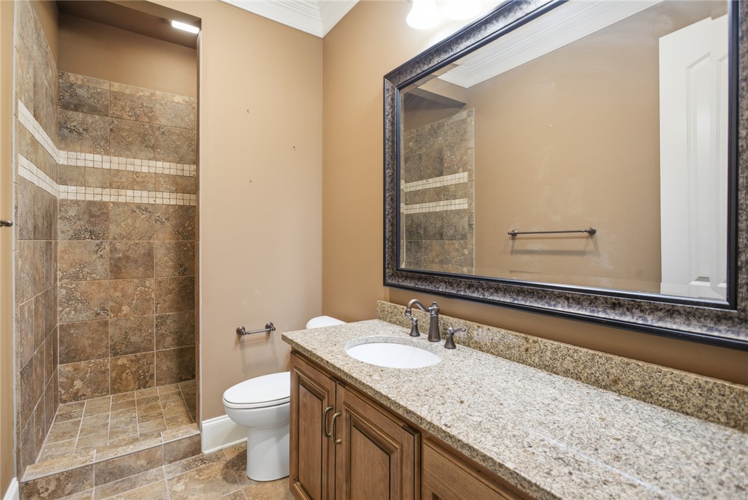 610 Highridge Drive Seneca, SC 29672 - Photo 47 of 50 This bathroom features elegant granite countertops, a spacious vanity, and a beautifully tiled walk-in shower.