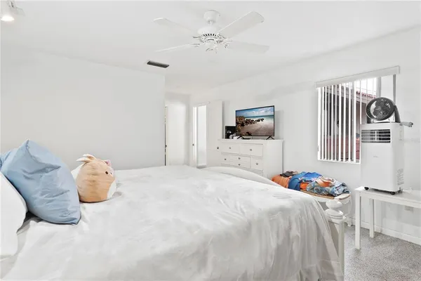 a room with a baby bed and a window