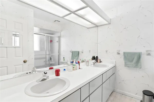 a bathroom with a sink toilet and shower