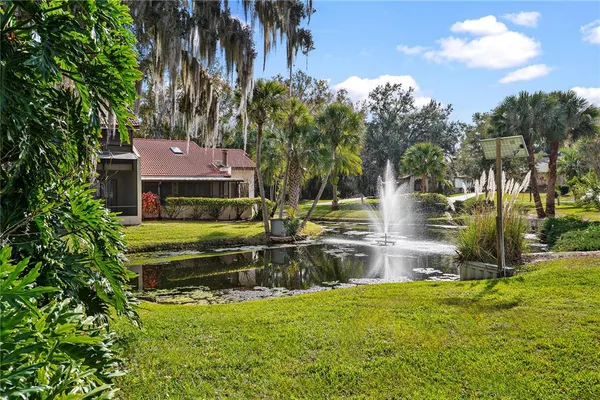 a kitchen with a lot of white cabinets and wooden floor