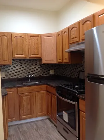 a kitchen with stainless steel appliances a stove a microwave and a sink