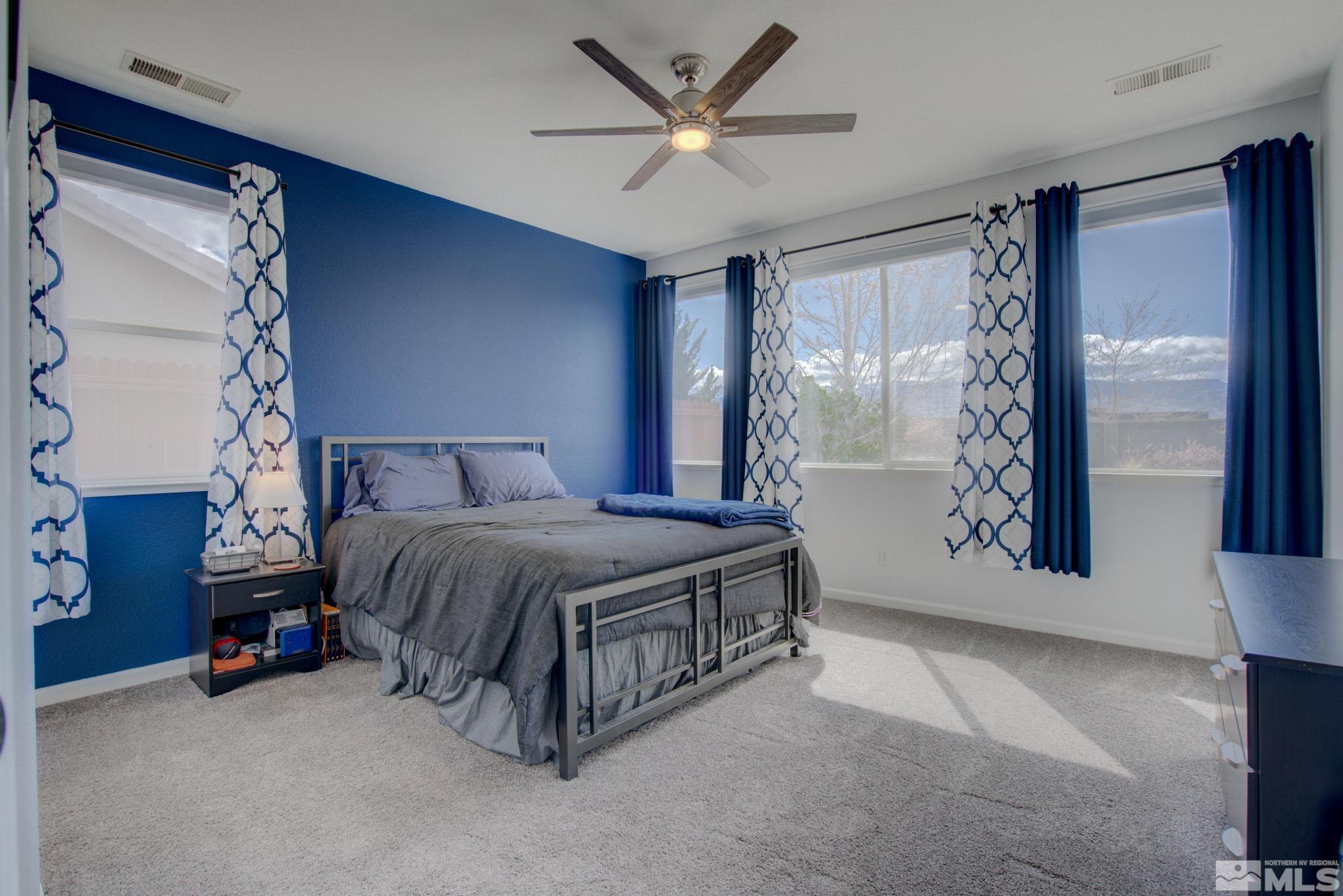 1625 Canyonlands Way Reno, NV 89521 - Photo 14 of 31 a spacious bedroom with a bed and a table