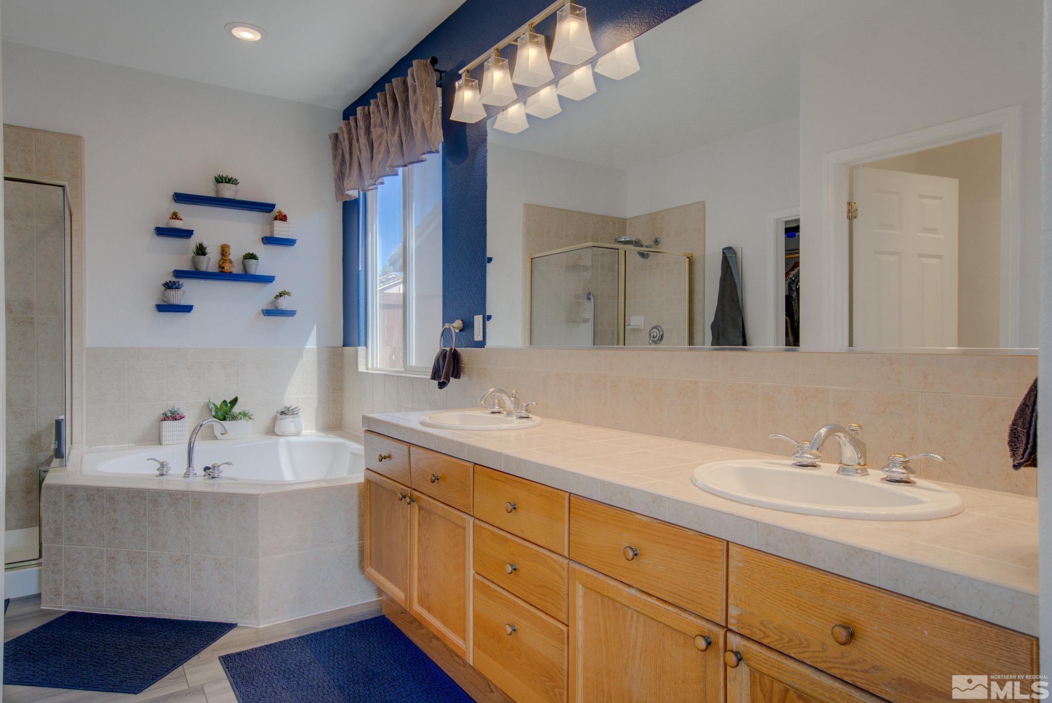 1625 Canyonlands Way Reno, NV 89521 - Photo 17 of 31 a bathroom with a sink double vanity granite and a shower