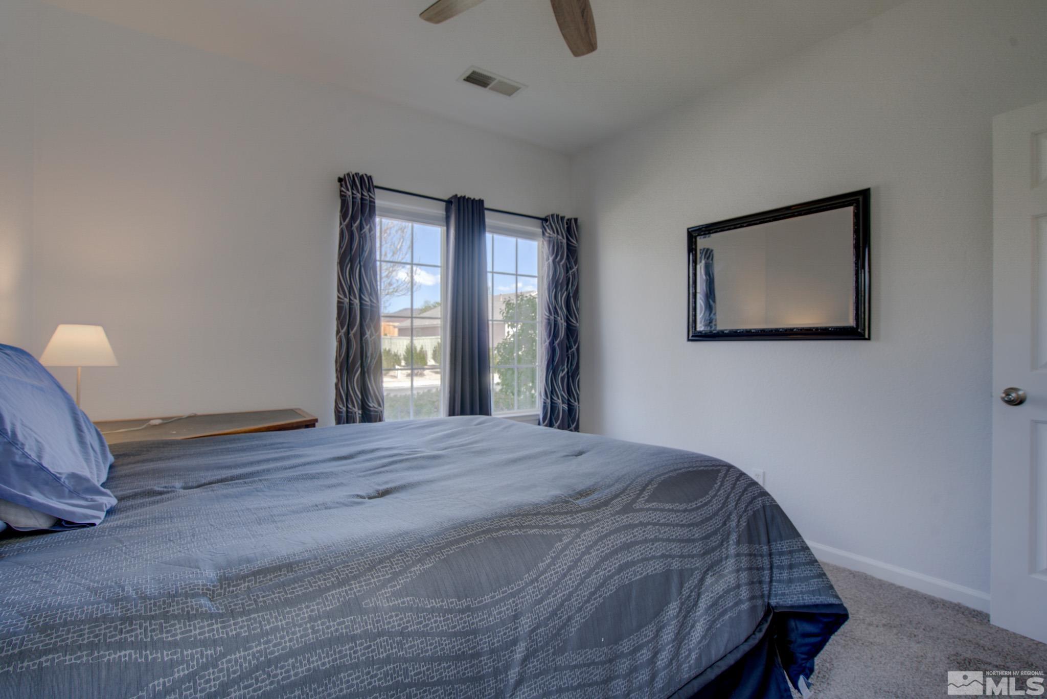 1625 Canyonlands Way Reno, NV 89521 - Photo 20 of 31 a bedroom with a bed and a window